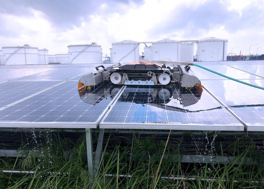 mechanized robot on top of solar panels cleaning them safely without scratching the surface